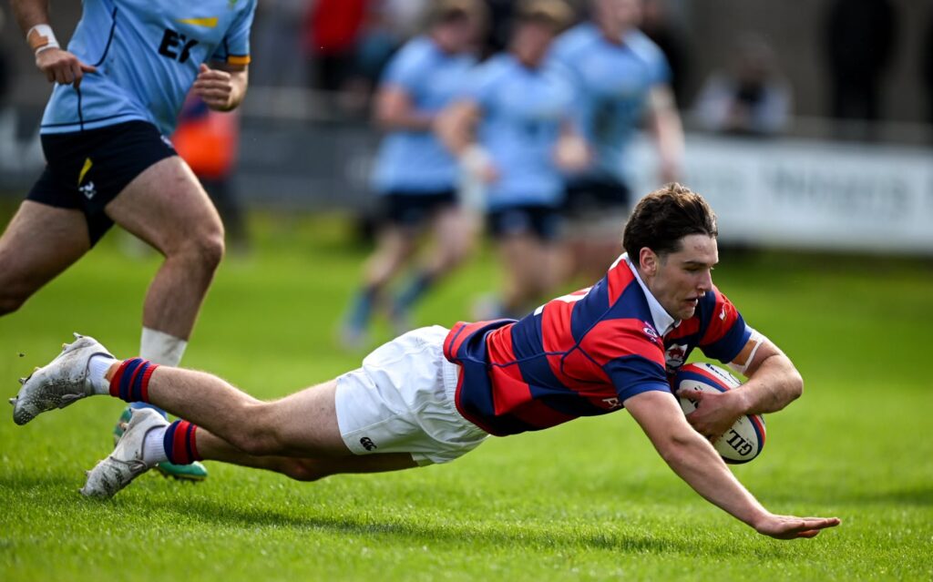 Clontarf’s Matthew Brennan scoring his team’s third try against UCD at Castle Avenue.